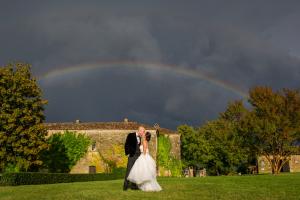 bride in her watters gown beneath the rainbow at chateau rigaud