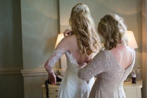 bride and her mother getting into wedding dress by sarah seven at babington house wedding