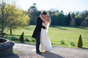 bride and groom enjoying a kiss at botleys manor in surrey before the wedding breakfast begins